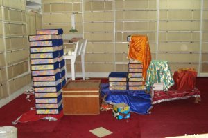 Holy Saroops of Sri Guru Granth Sahib Ji stacked like bricks, many of them uncovered.