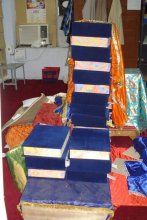 Holy Saroops of Sri Guru Granth Sahib Ji stacked like bricks, many of them uncovered.