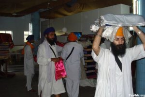 Guru Granth Sahib Satkar Committee Members moving some of the Saroops into the Sukhasan Room