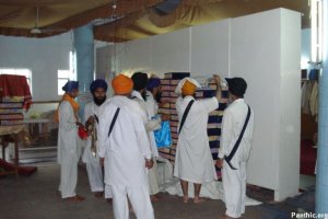 Guru Granth Sahib Satkar Committee Members moving some of the Saroops into the Sukhasan Room