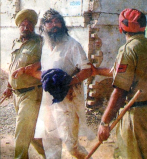 The same GurSikh is being escorted by the police after assaulted by SGPC 'task force'.